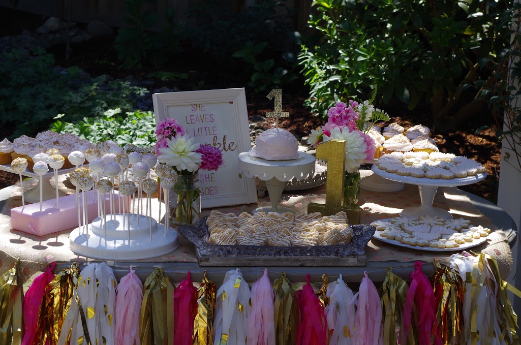 pink and gold dessert table first birthday party for little girl
