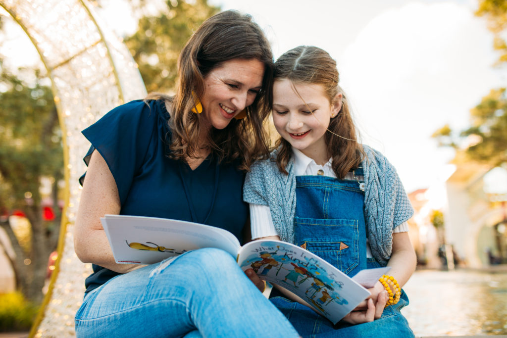 Mother and daughter reading a book for quality time. Want to know the secret to raising kind kids and teaching kindness in an easy way? Nicole Black, Coffee and Carpool, shares how on this parenting podcast!