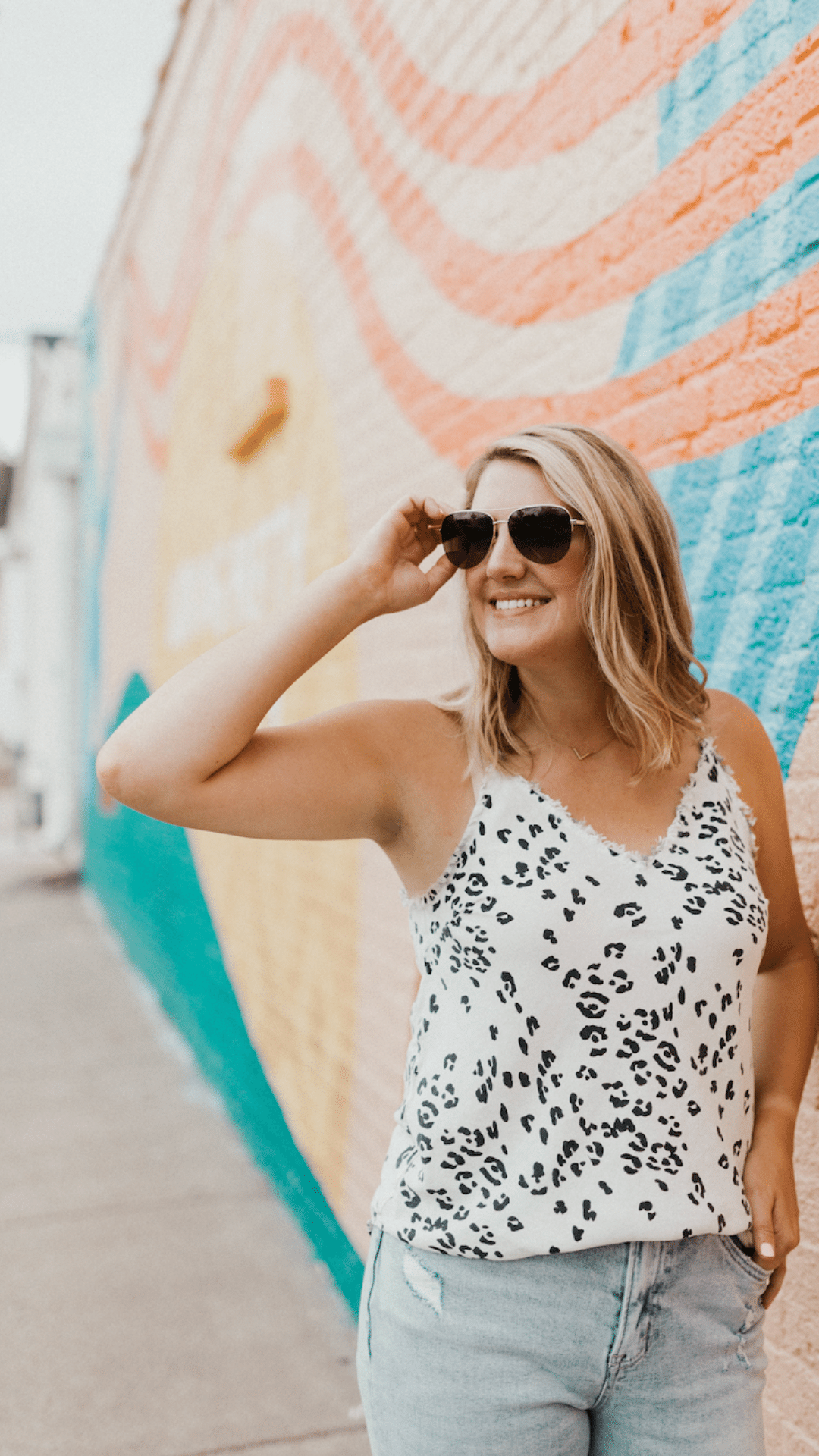 blonde woman posing with sunglasses - talks about how to build your personal brand